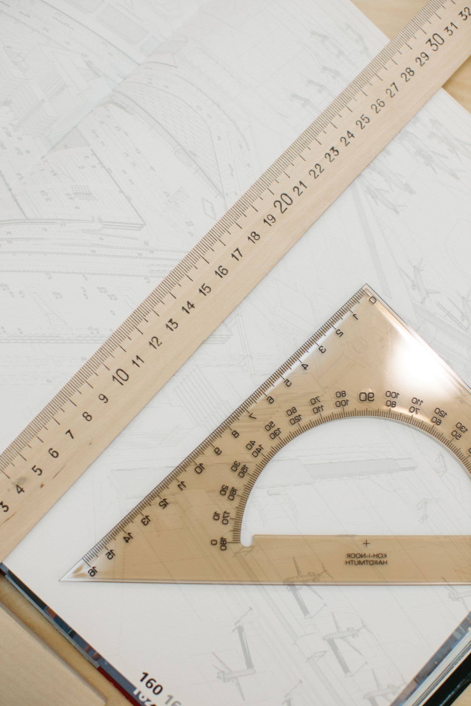 A ruler and set square on a work surface