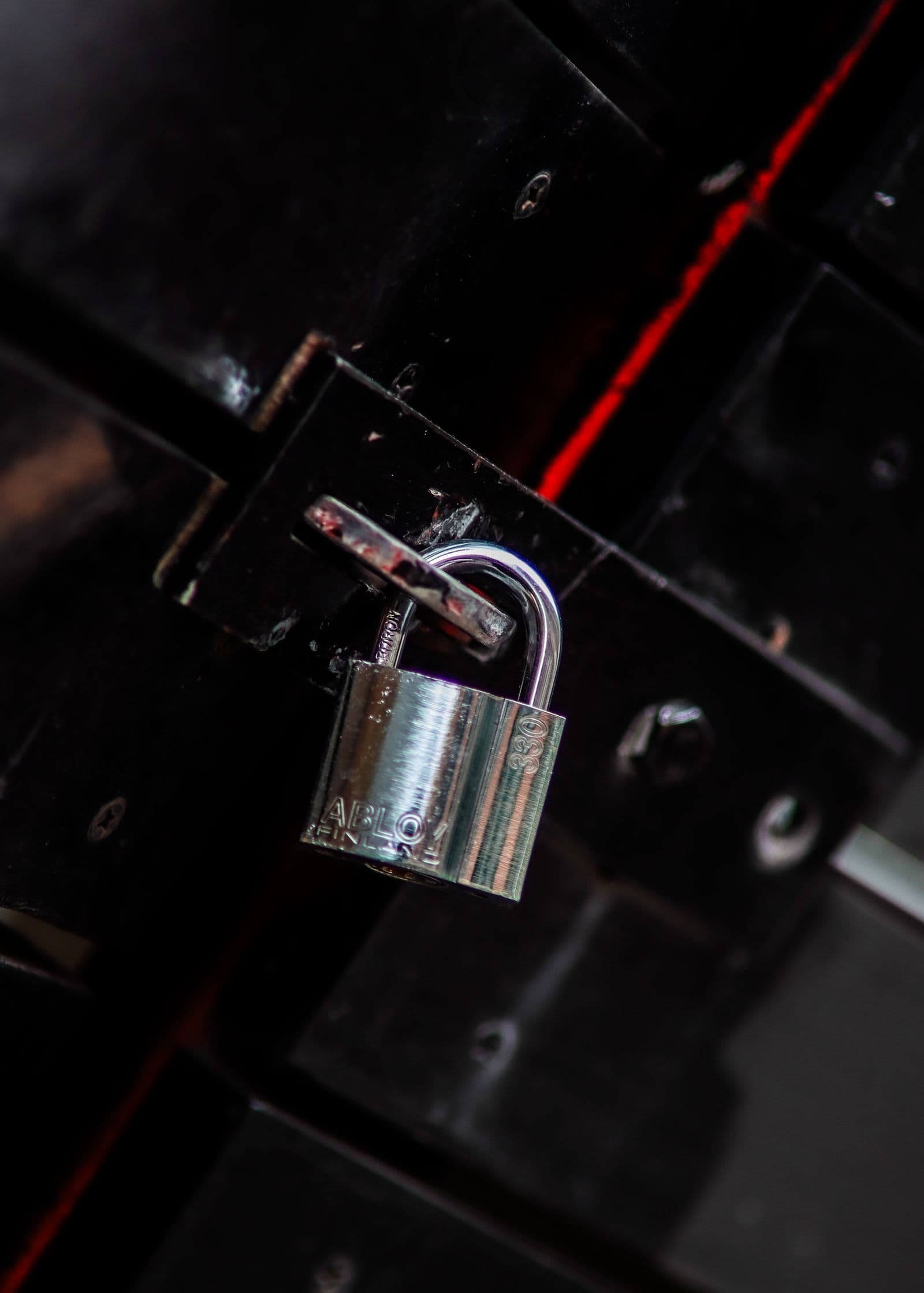 A padlock on a dark metal gate