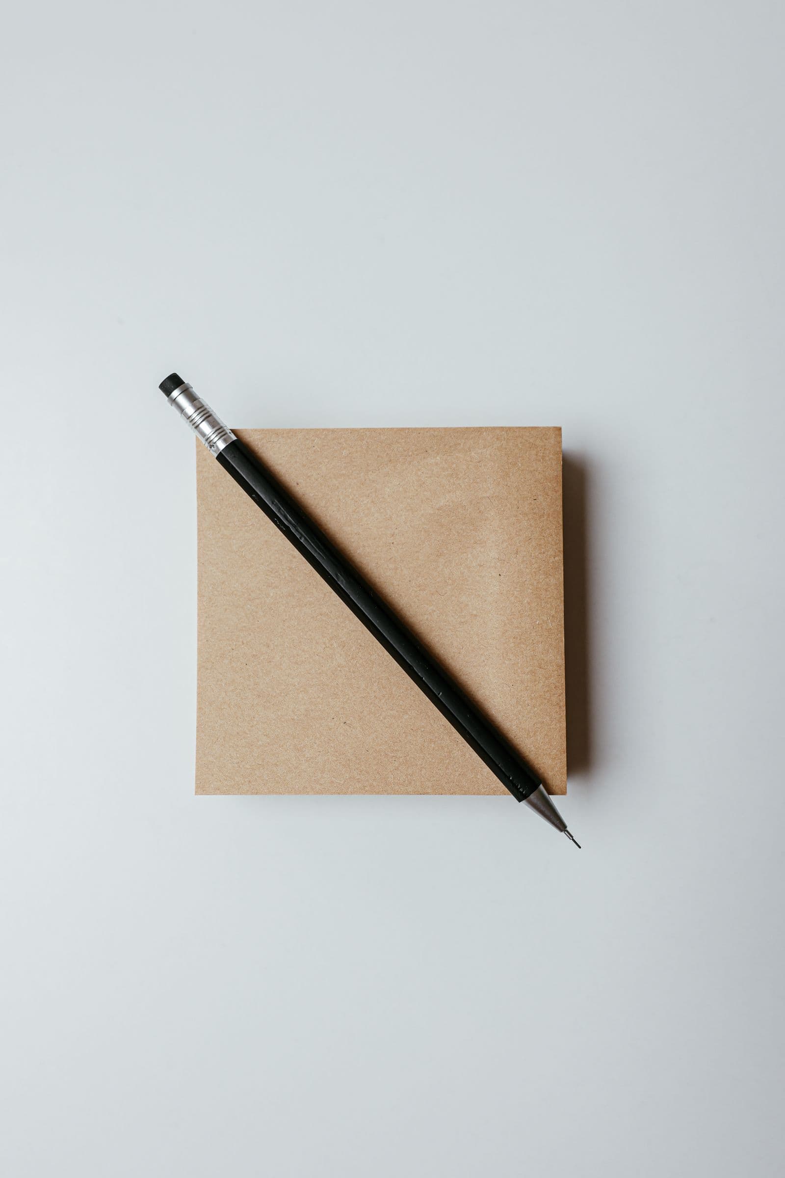 A pencil resting on a plain envelope