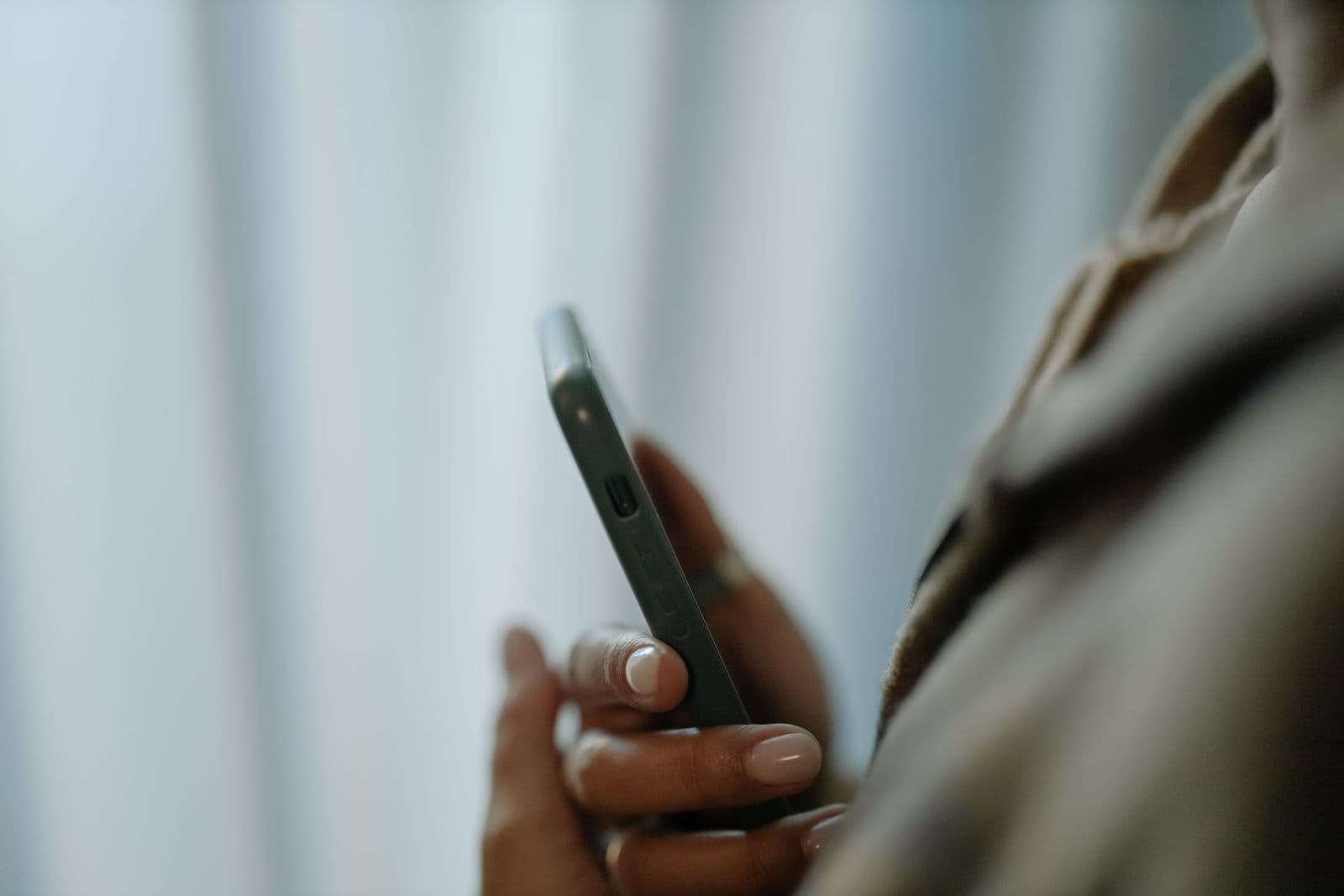 A person checking a phone outdoors