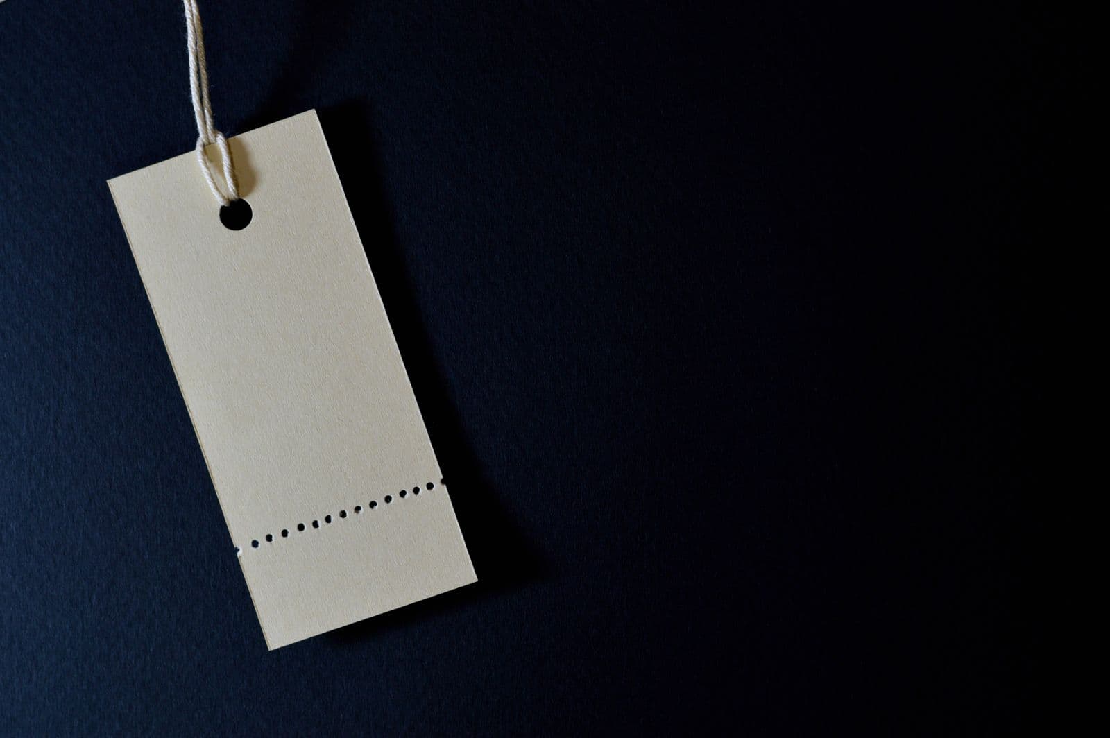 A blank price tag against a dark background