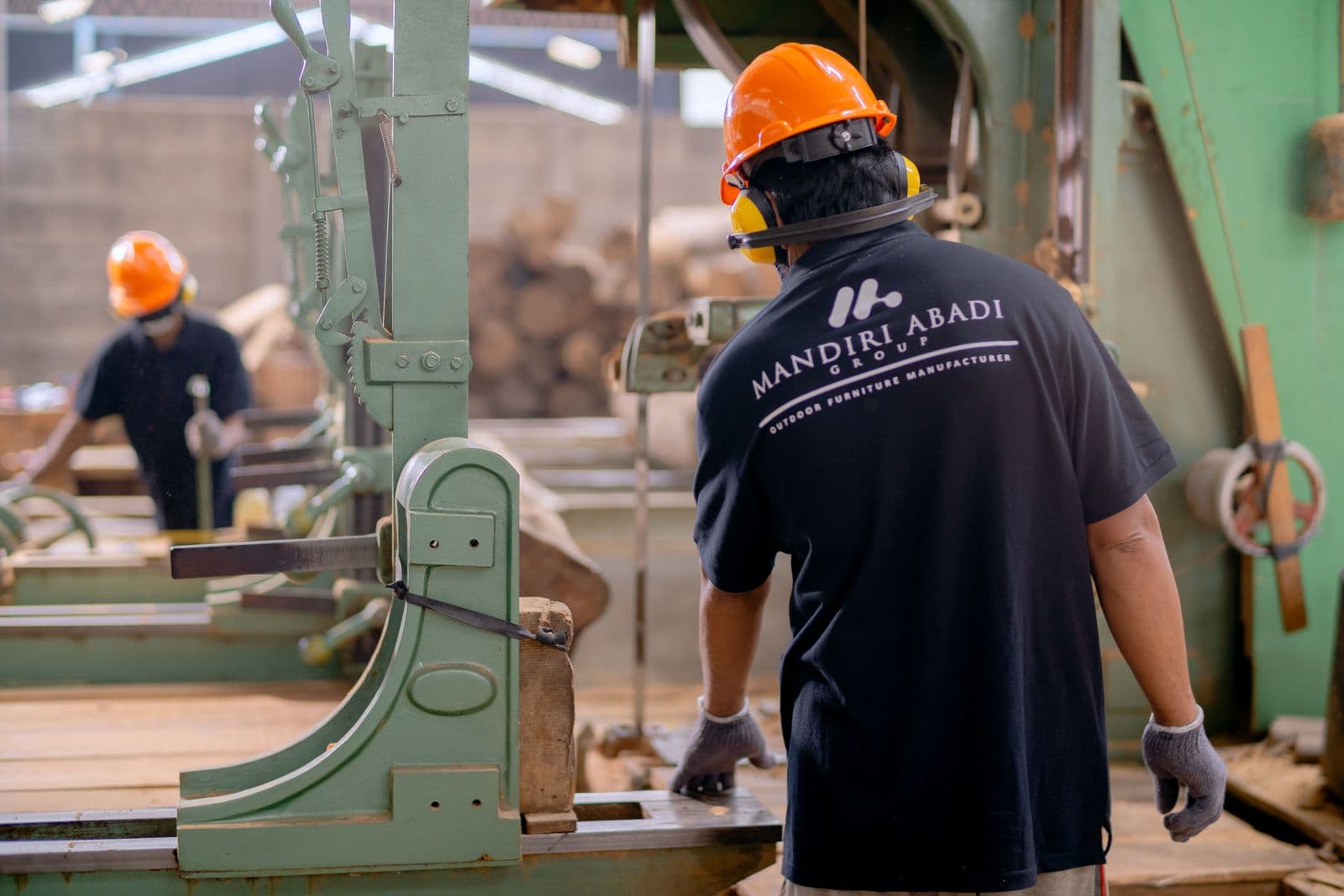 A worker operating machinery in a workshop